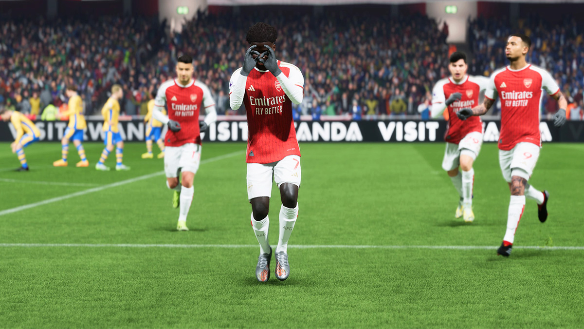Bukayo Saka hitting the Griddy at Arsenal with teammates around him.